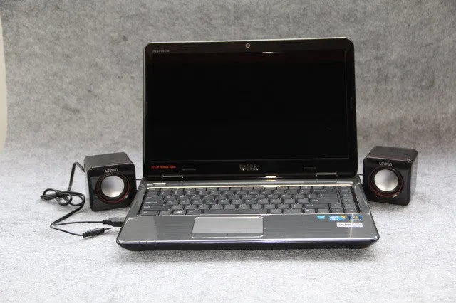 Black, small square USB-powered 2.0 computer speaker for desktop use.