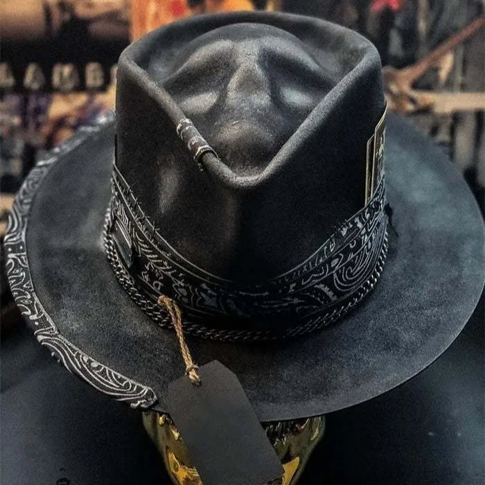 Handmade grey wool felt conical hat with a black embroidered skull design on the front.