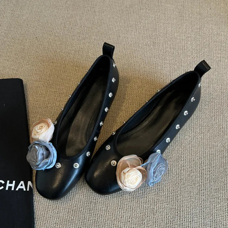 Women's silver Mary Jane loafers with flower rivets, buckle strap, round toe, and flat rubber sole.