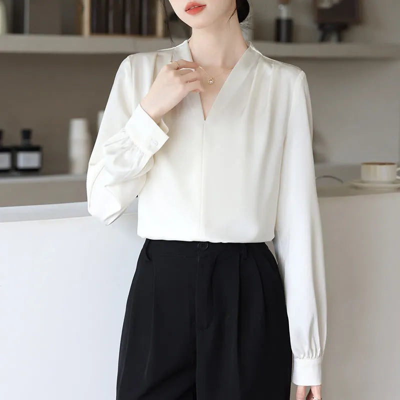Women's blue satin shirt with long sleeves and slim fit showing 3D stitching detail
