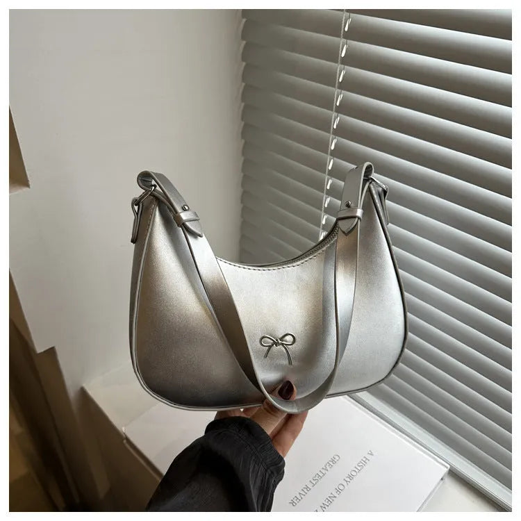 Women's underarm small shoulder bag in dumpling shape, shown in one of six colours: white, black, pink, khaki, brown, or silver.