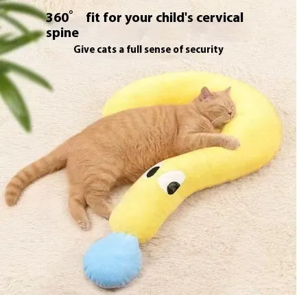 Blue and yellow U-shaped cat pillow in moon and question mark designs on a wooden floor.