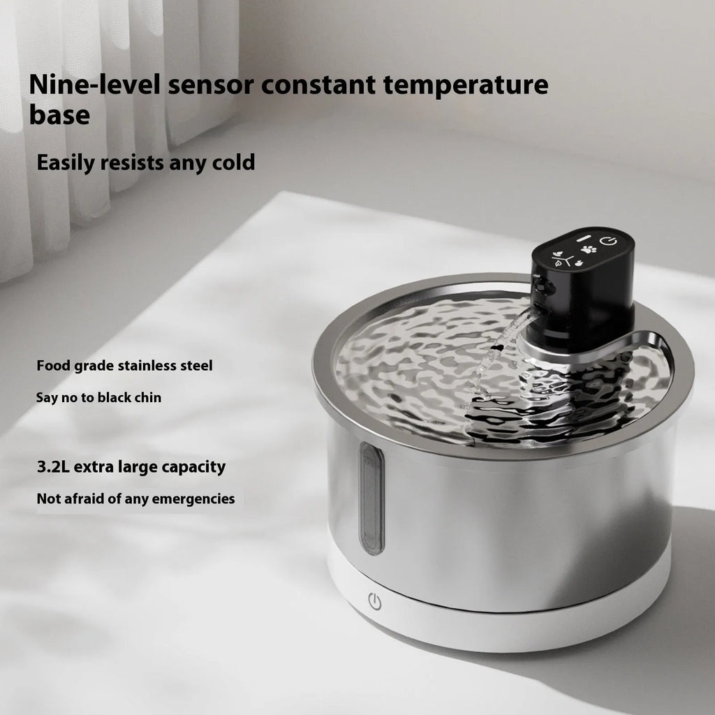 Stainless steel cat water fountain with white heating base and control panel.