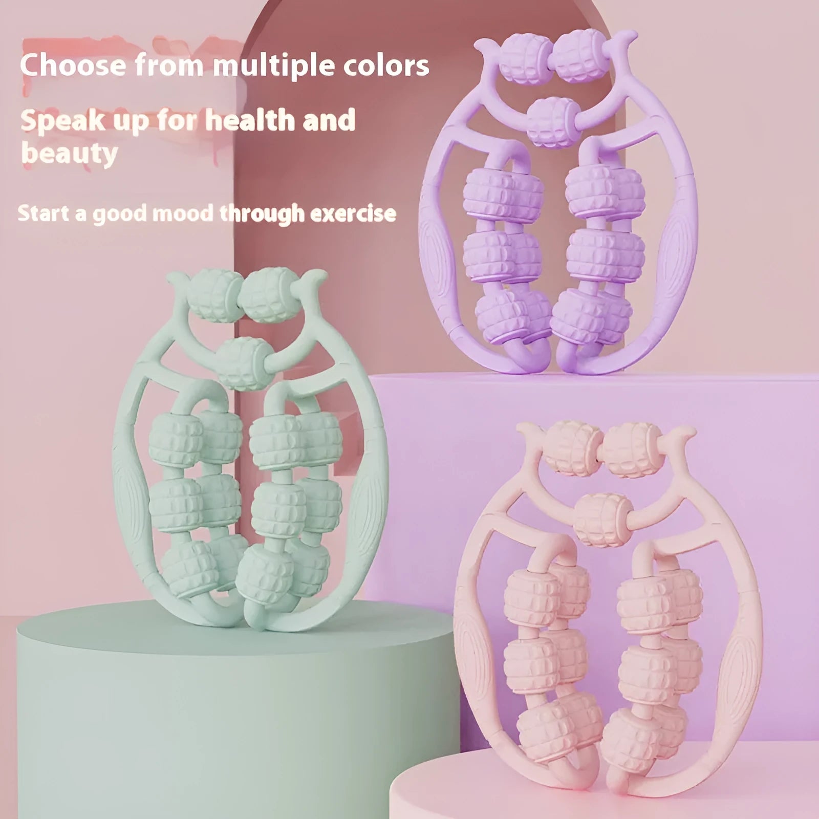 A small, handheld leg massage roller with double-row wheels in coral pink, shown on a table.