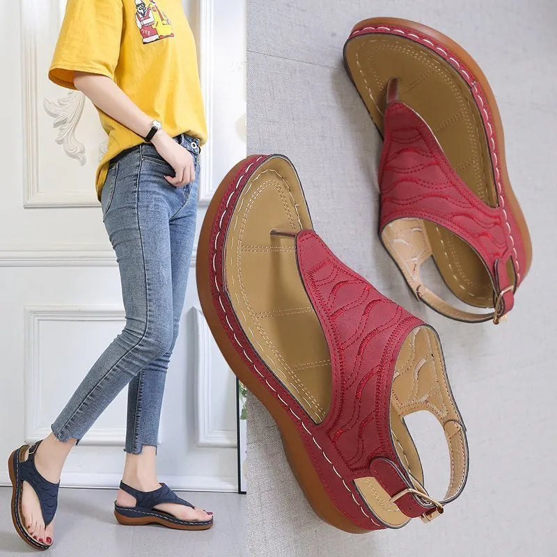 Women's wedge heel casual sandals in red with an adjustable back strap and flip-flop style.