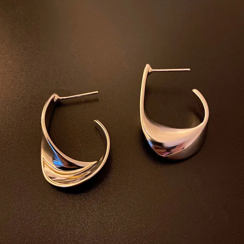 Twisted geometric metal earrings with circular design in gold or silver electroplated finish