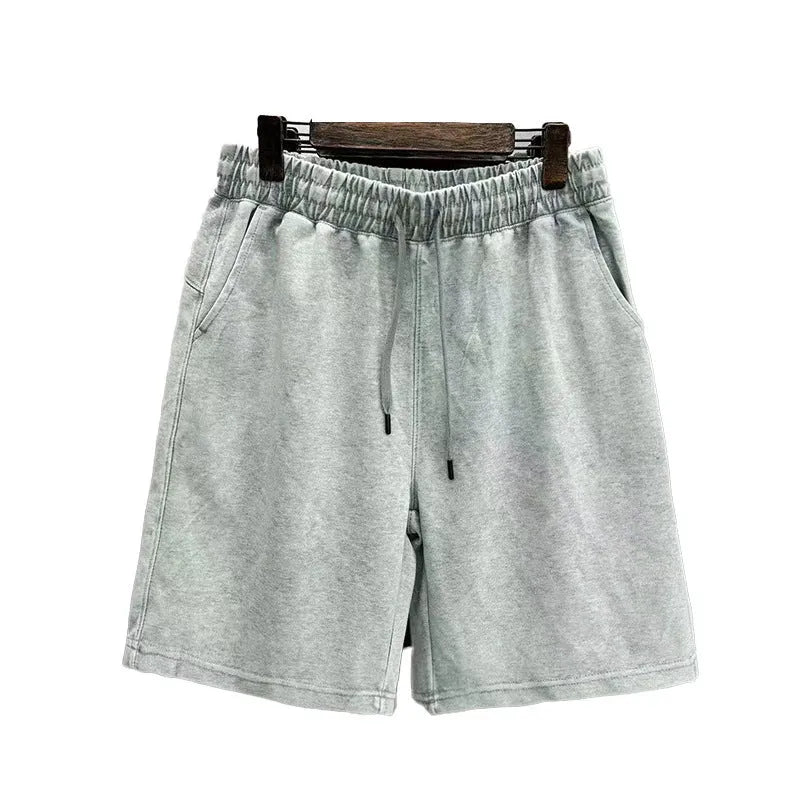 Men's distressed cotton shorts in straight loose fit with solid colour options