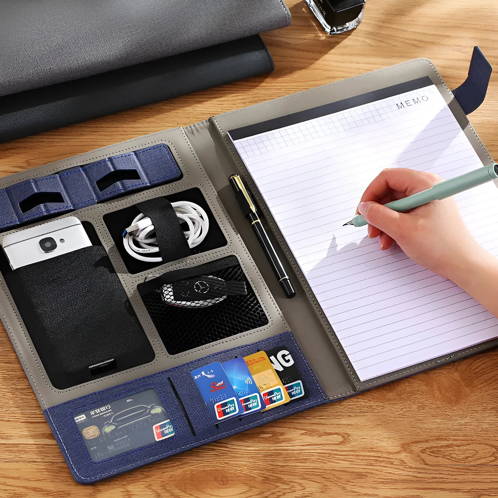 Black leather A4 document folder showing 35mm padded thickness, open to reveal interior pockets and an optional pen and notepad.