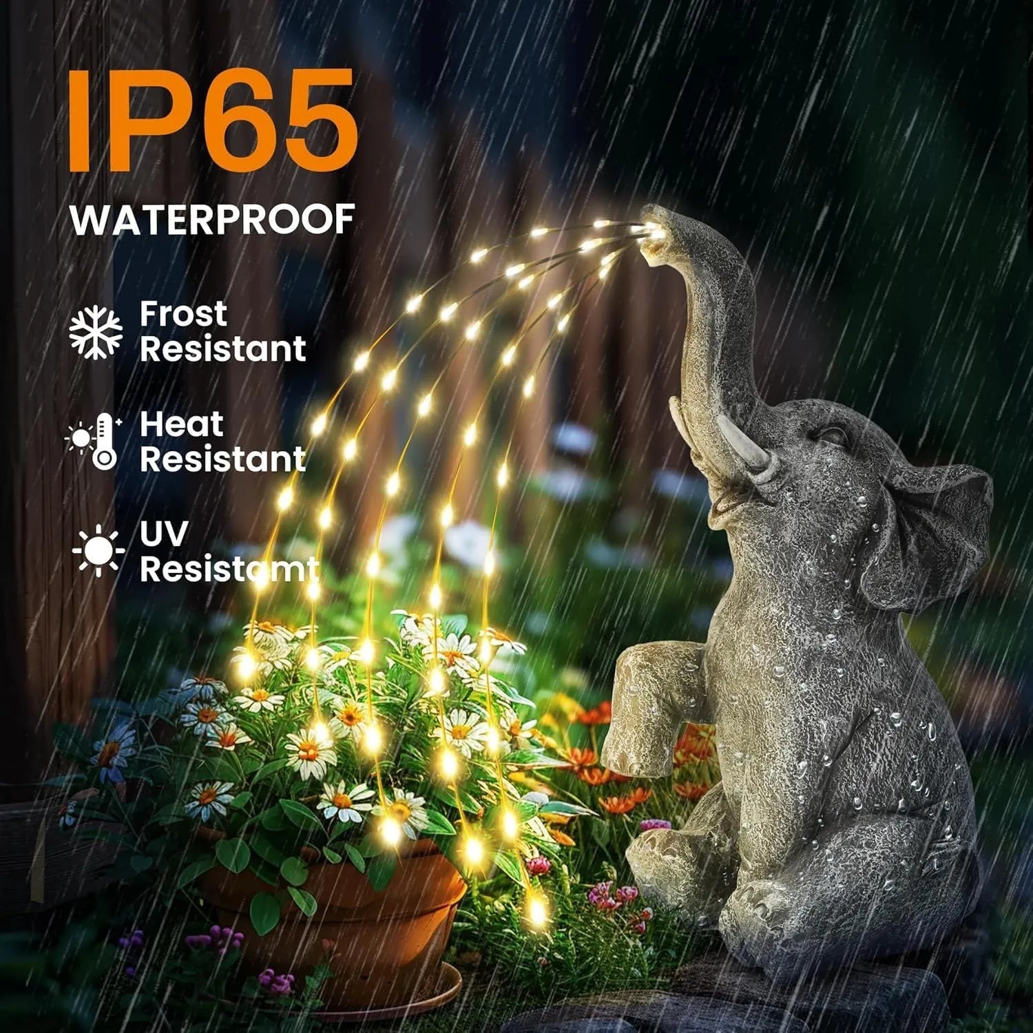 Grey resin elephant garden statue with warm white LED light glowing at its base on a patio.