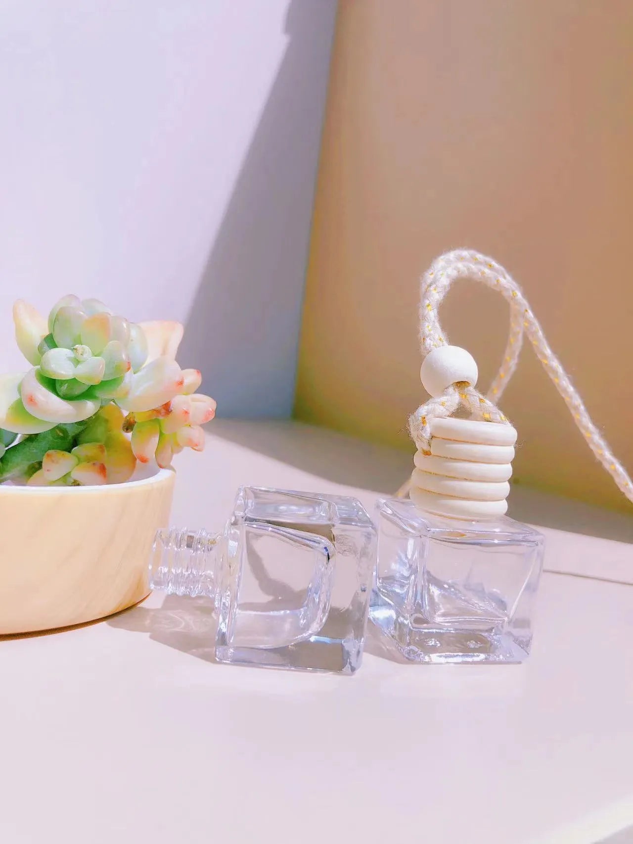 Glass car fragrance pendant showing Cylinder, Diamond, Flat Drum, and Square bottle style options.