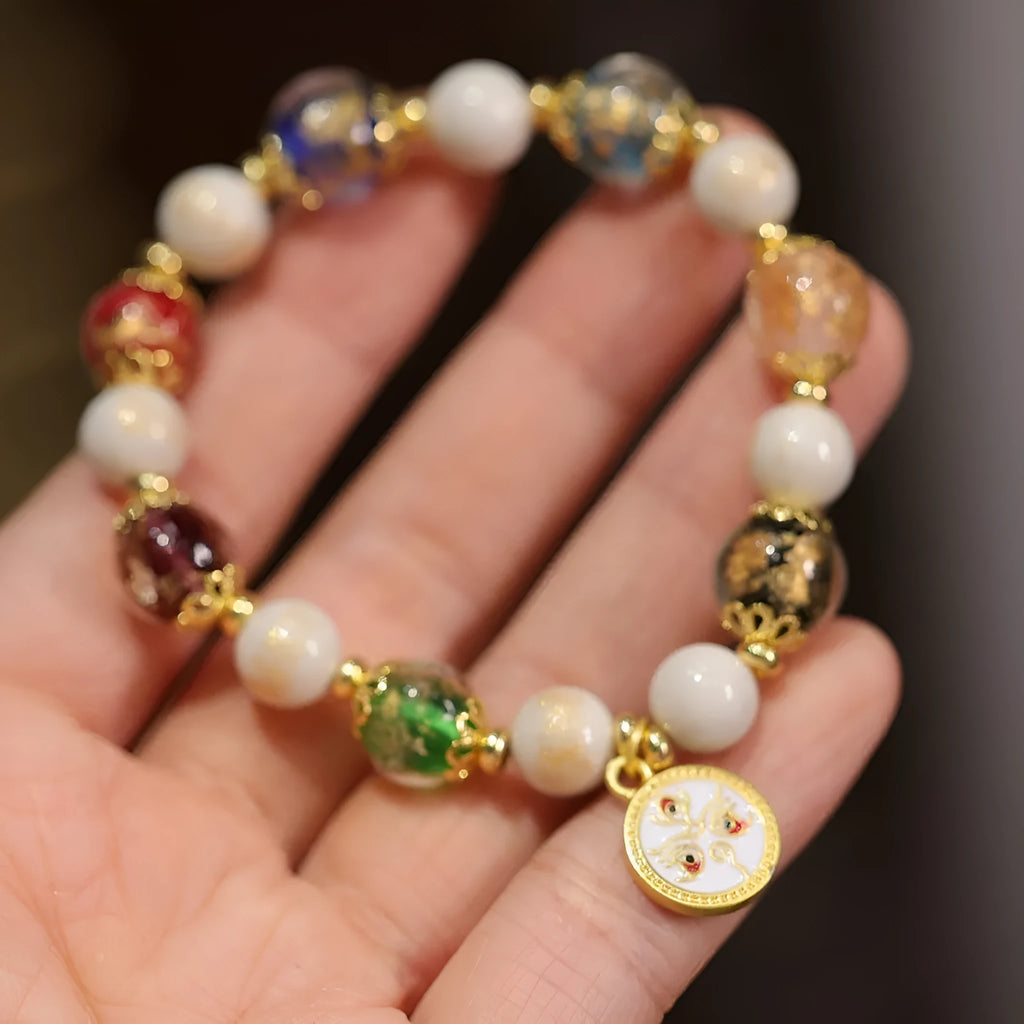 Handmade coloured glaze bracelet with 10mm glass beads showing gods of wealth motifs in national style design