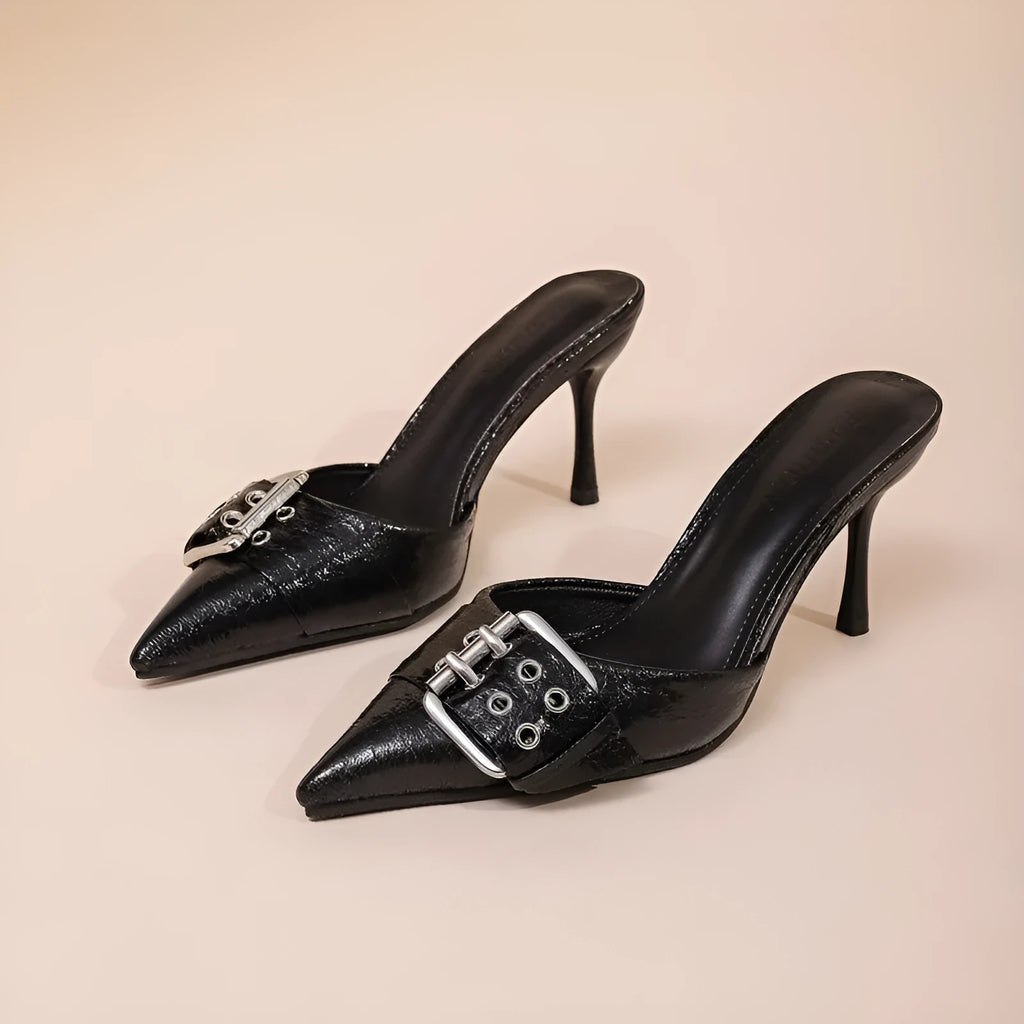 Black women's high heels with pointed toe and buckle decoration on ankle strap.