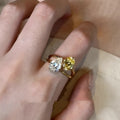 Geometric open-back silver ring with large central pear-cut clear zircon stone on a model's hand.