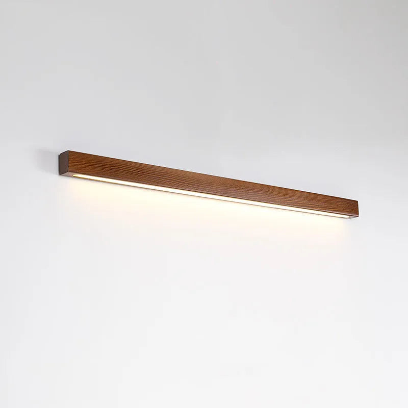 Walnut-coloured wooden log strip wall lamp with acrylic elements and integrated LED lighting.