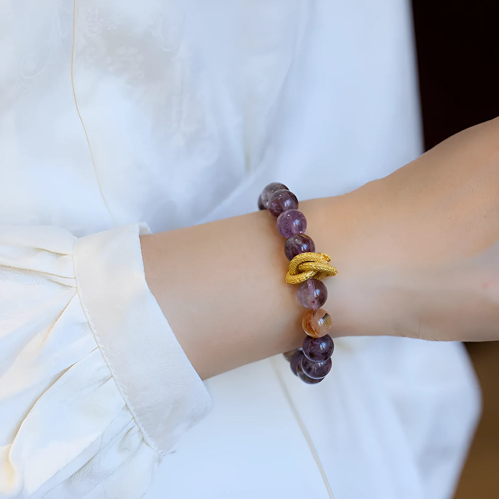 Purple cornucopia nine purple good luck crystal bracelet with zodiac animal motifs on wrist