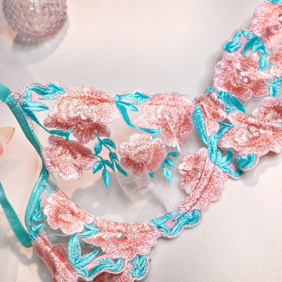 Pink women's bikini set with embroidered mesh pettiskirt and matching strappy top.