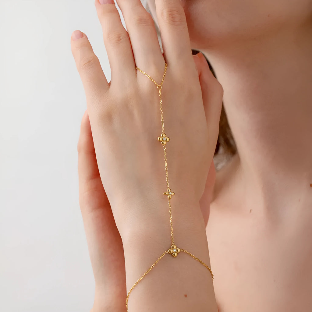 Gold geometric women's bracelet with floral and eight-pointed star design on stainless steel