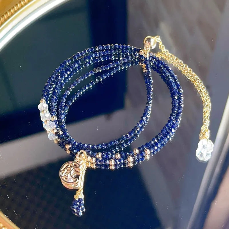 Blue gold sand stone three-ring multi-layer bracelet for women on a white background.