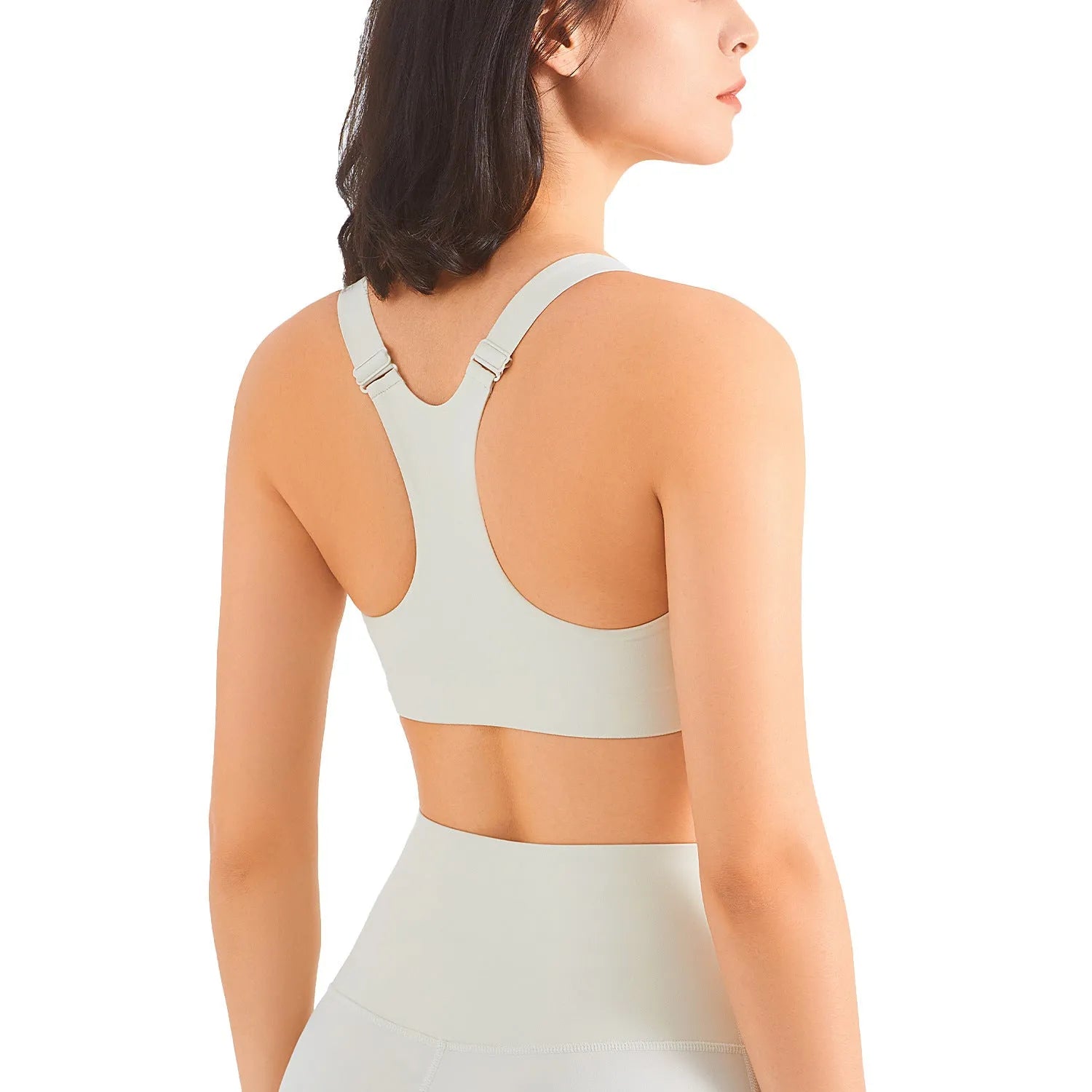 Zip front sports bra in pink lychee colour showing racerback shape and mesh back panel