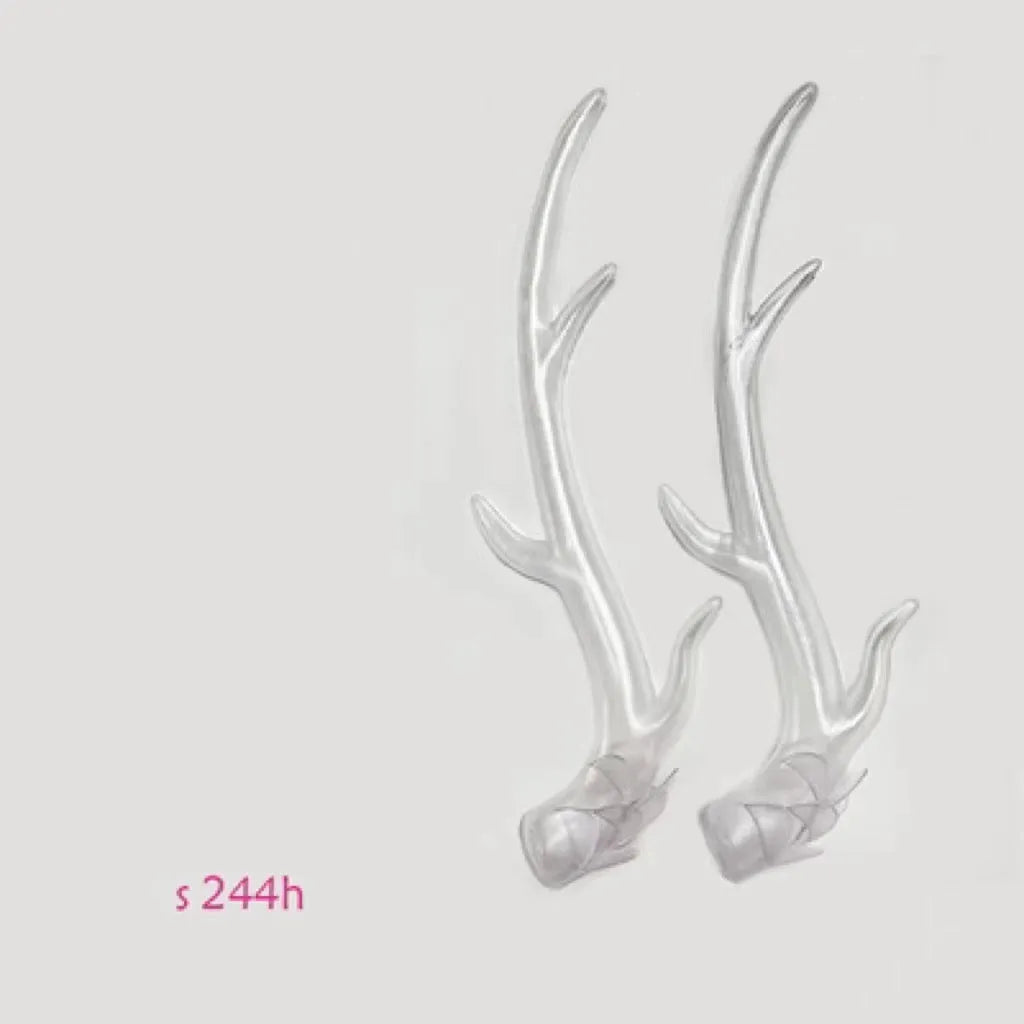 A pair of black resin dragon horn decorations for motorcycle helmet customisation, showing curved shape and mounting base.