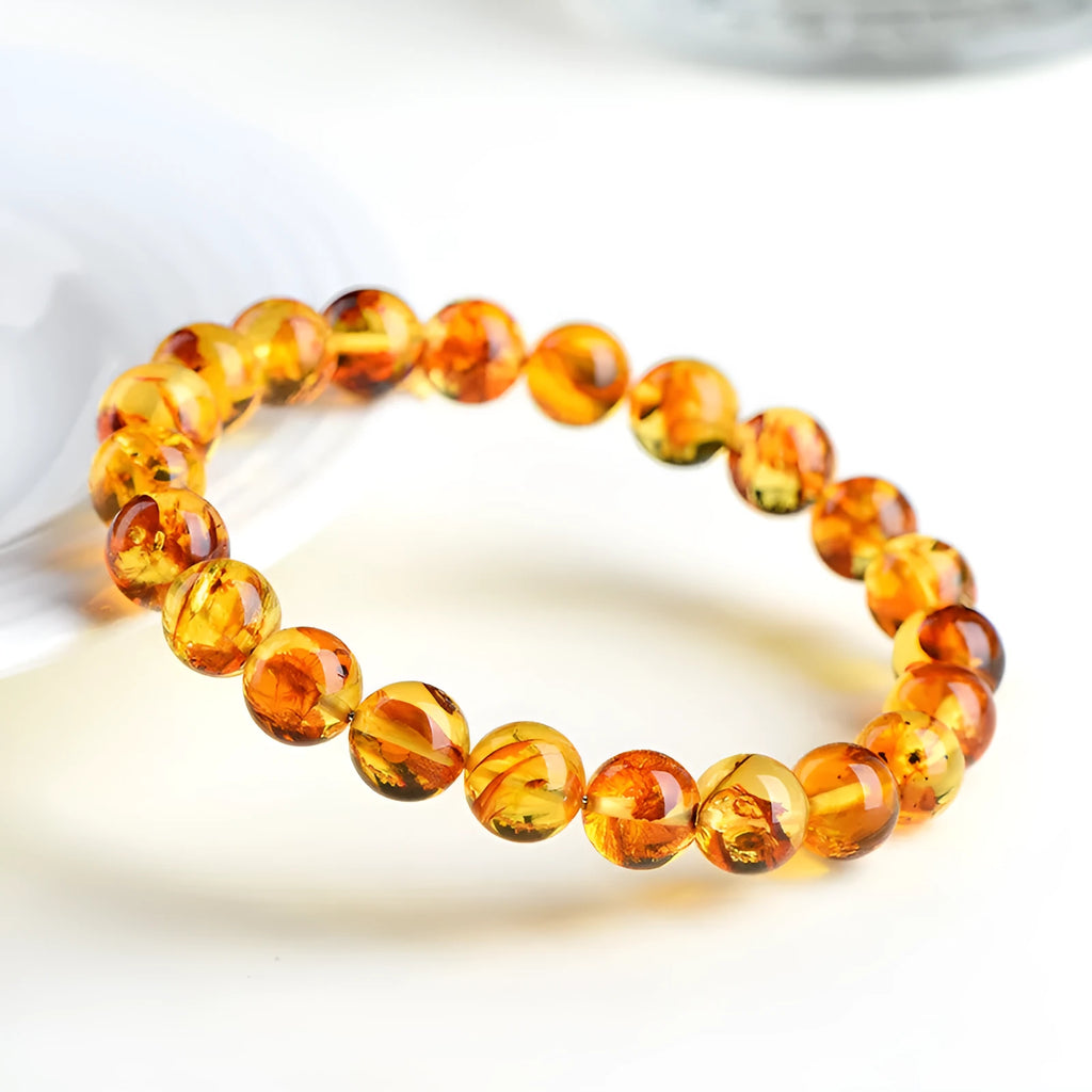 A natural yellow piebald amber bracelet with geometric beads for water purification.