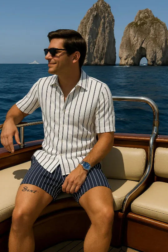 Men's light blue beach shirt and matching shorts set laid flat, showing casual style and elastic fabric texture.