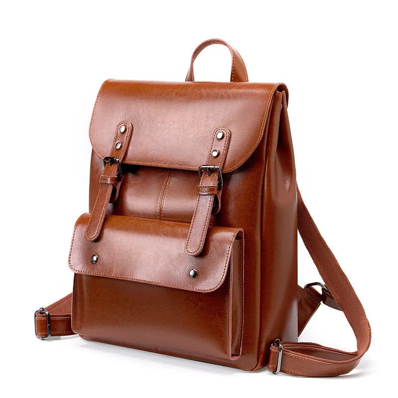 Black two-layer cowhide leather computer backpack for women with internal lining.
