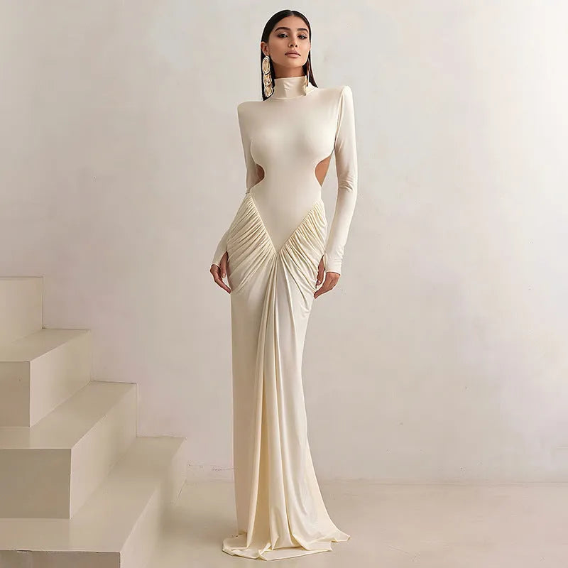 A woman's long sleeve high collar slim fit dress in a solid colour with a pleated backless detail.