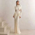 A woman's long sleeve high collar slim fit dress in a solid colour with a pleated backless detail.