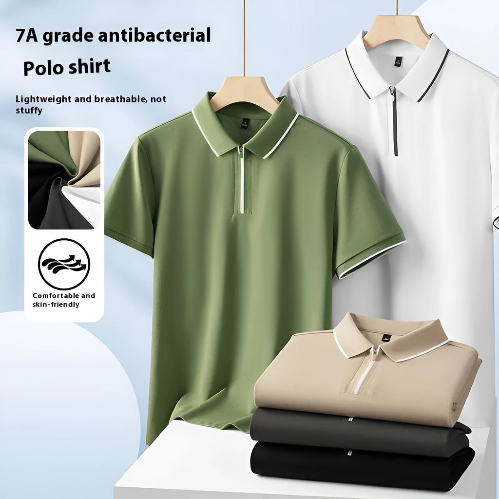 Man wearing a solid colour zip-front short-sleeve polo shirt in a casual setting.