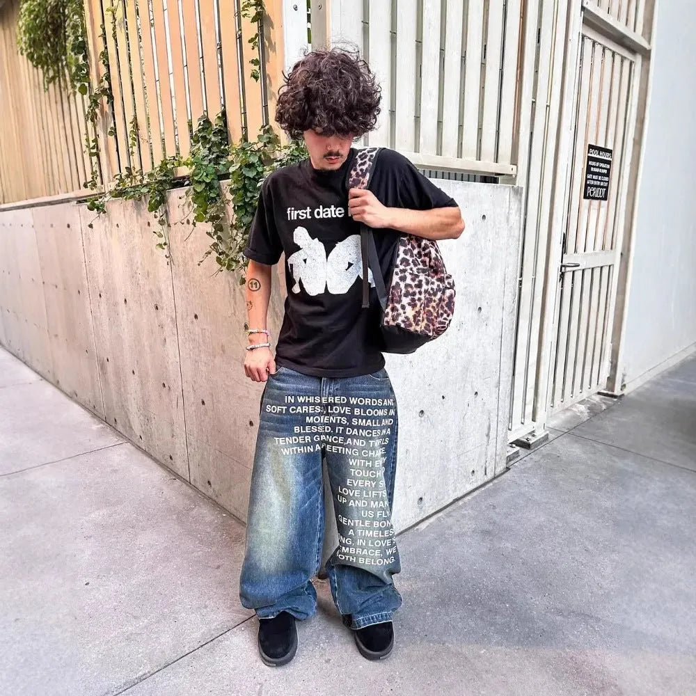Man modelling black loose wide-leg straight cotton casual trousers with an elasticated waistband.