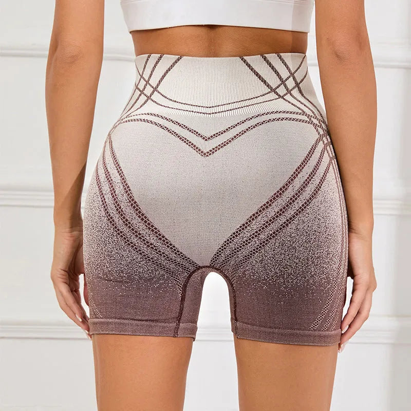 Women's high-waisted gradient fitness shorts in black, shown on a model.
