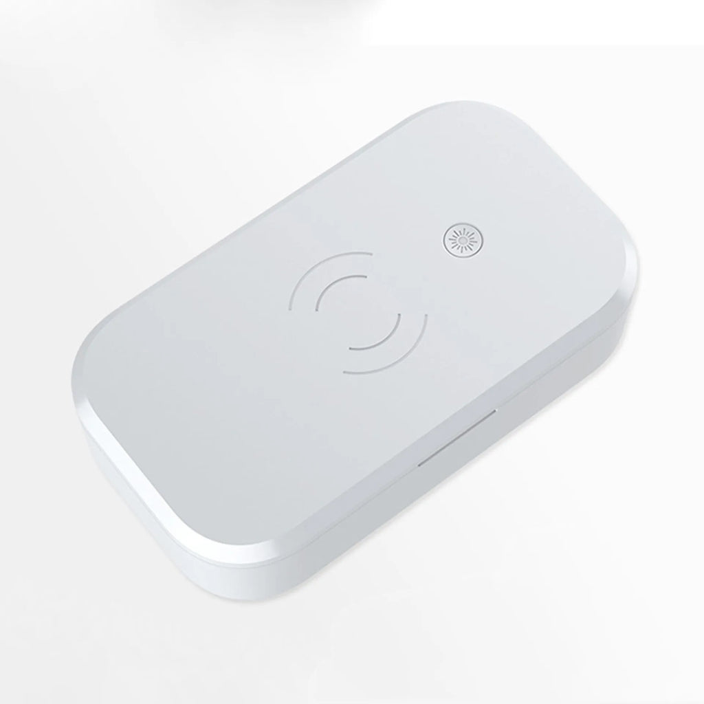 White ultraviolet disinfection box with wireless phone charging pad for nail tools.