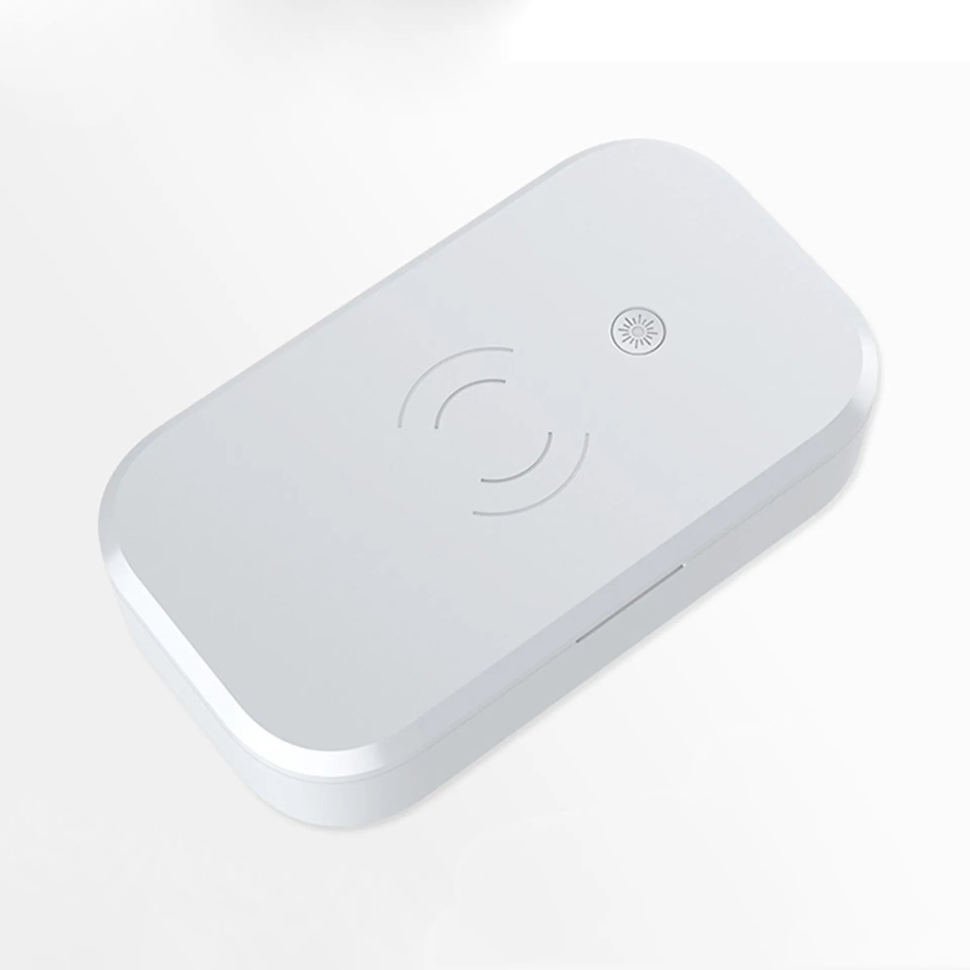 White ultraviolet disinfection box with wireless phone charging pad for nail tools.
