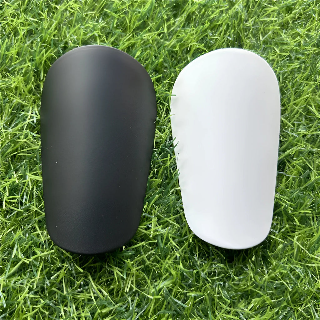Extra small mini football shin guards in black and white plastic for youth players