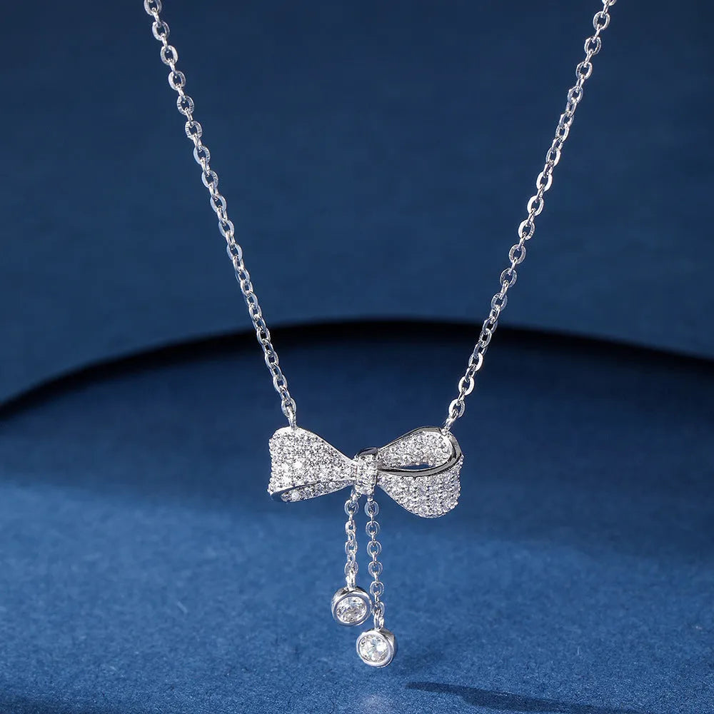 Sterling silver bow pendant necklace with O-ring chain on a 40-45cm adjustable chain.