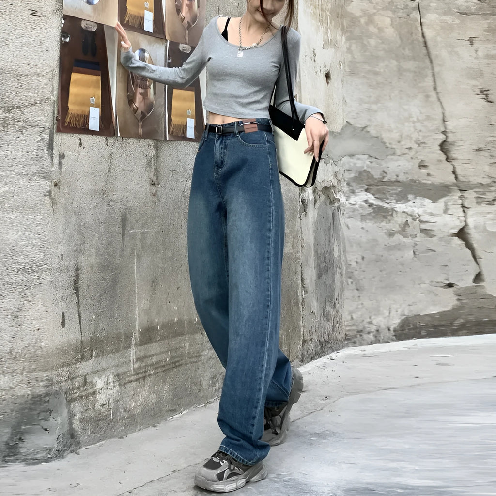 A woman wearing high-waist straight leg jeans in a retro blue colour, showcasing the classic denim fit.