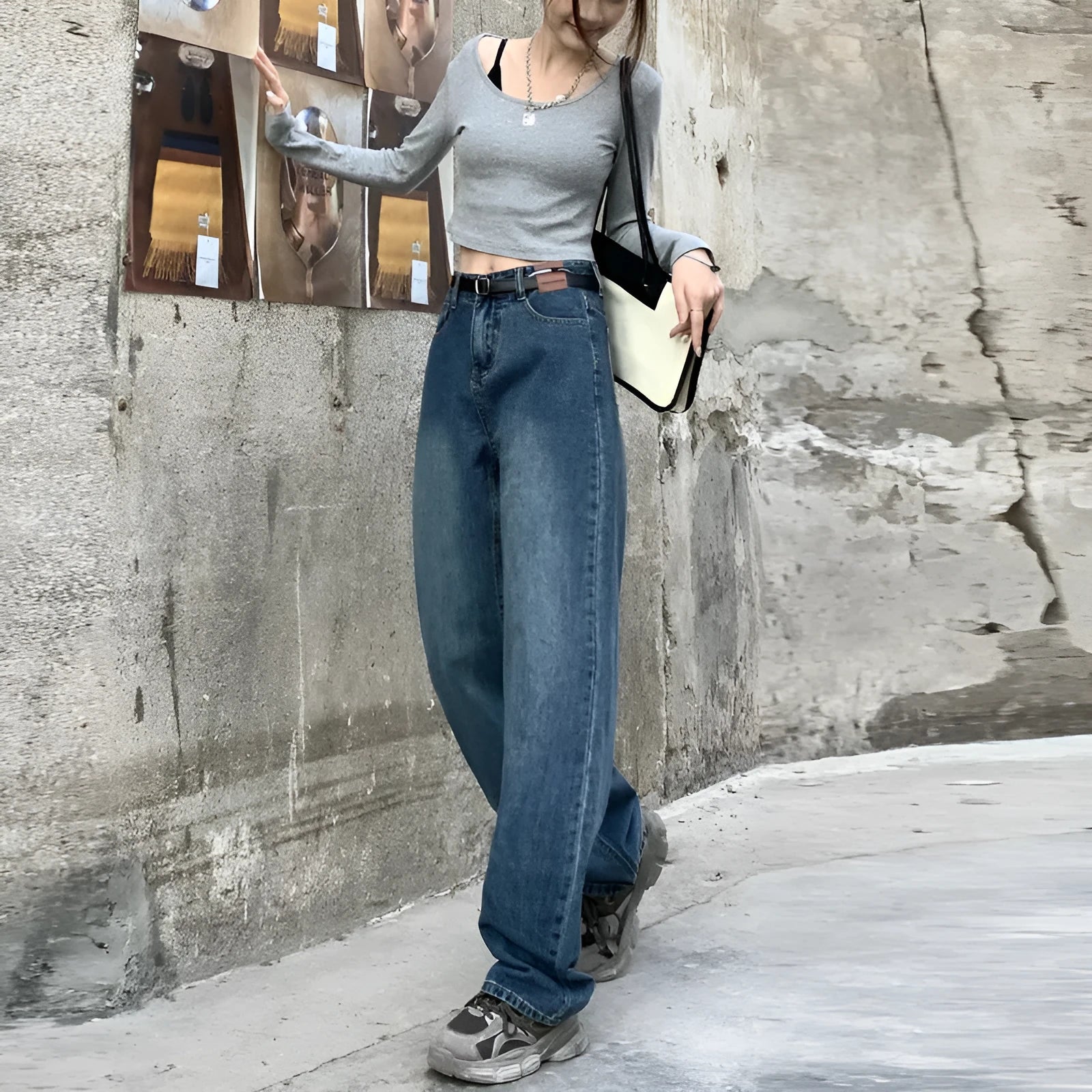 A woman wearing high-waist straight leg jeans in a retro blue colour, showcasing the classic denim fit.