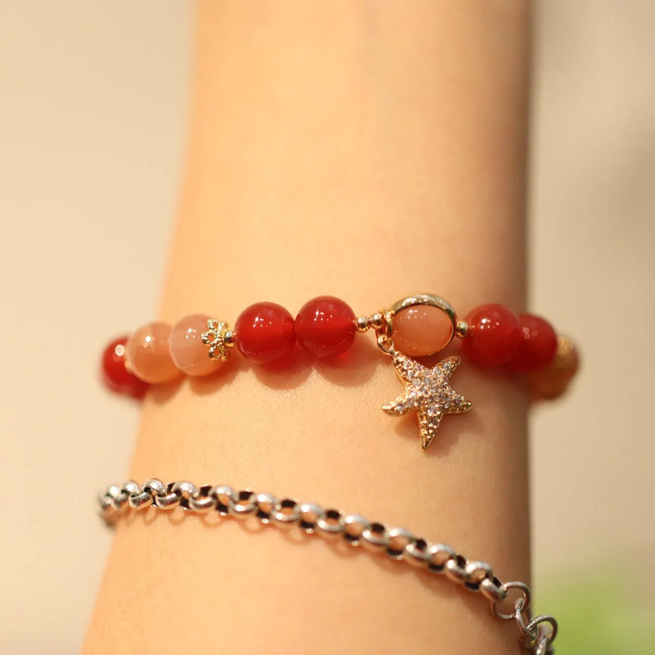 Handmade women's bracelet with 8mm red agate and orange sunstone beads, featuring star and cloud designs.