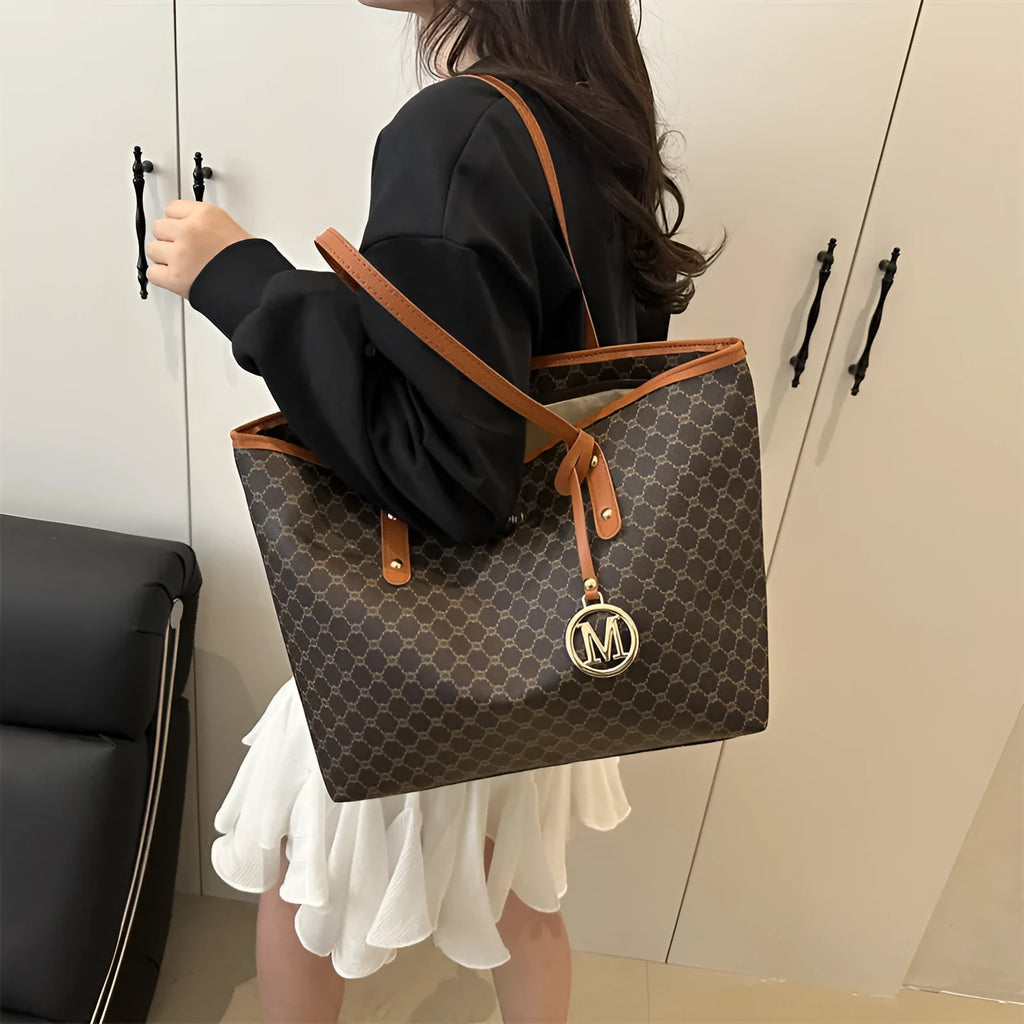 PU leather shoulder bag with adjustable strap in black, shown with visible stitching detail.