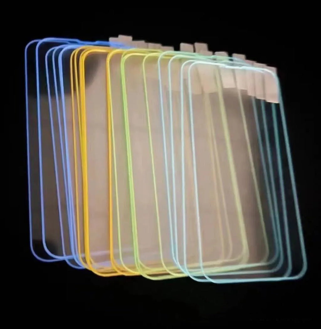 Fluorescent blue tempered glass screen protector glowing on an iPhone 13 in a dark setting.
