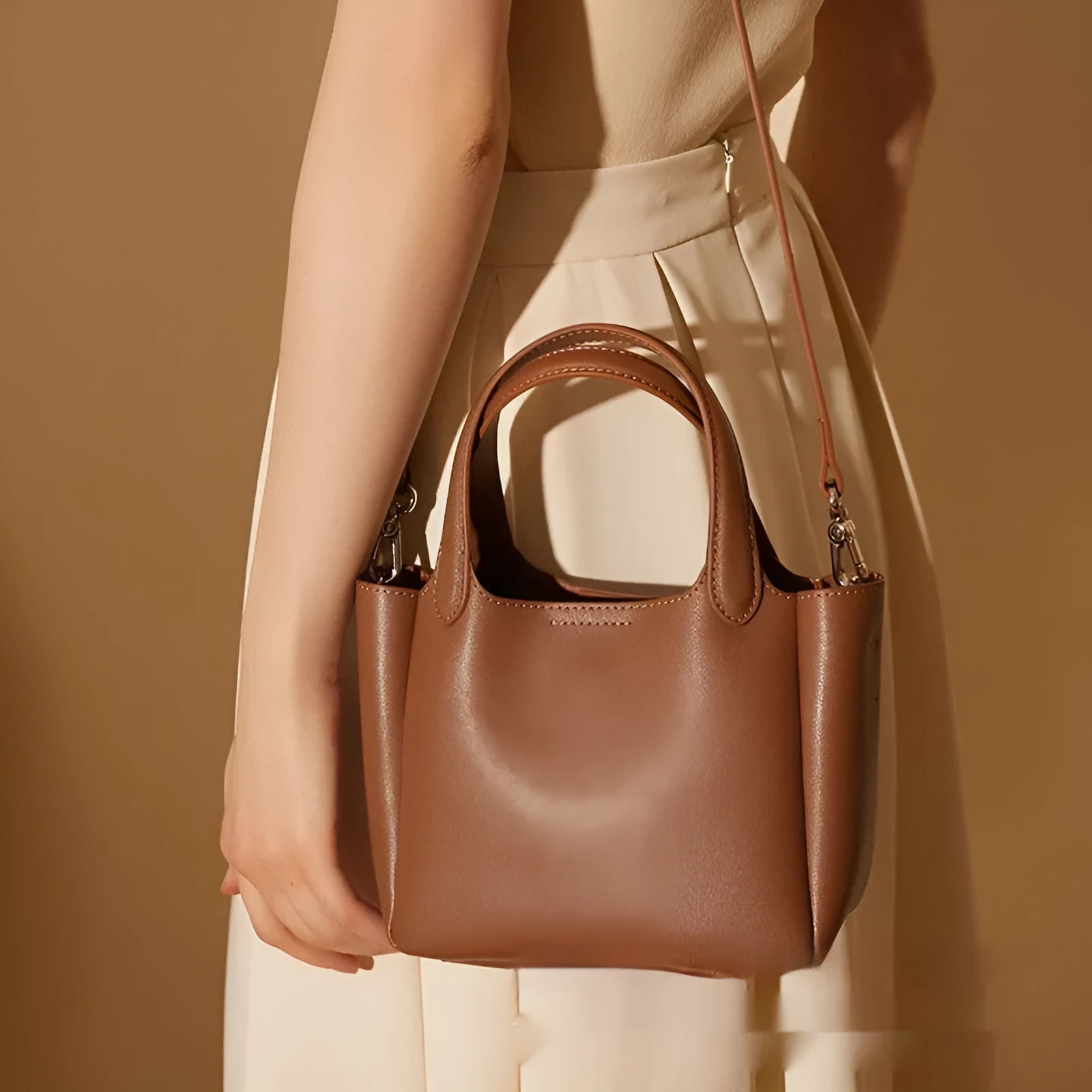 Genuine cattlehide leather retro cross body bucket bag in square vertical shape shown in brown colour.