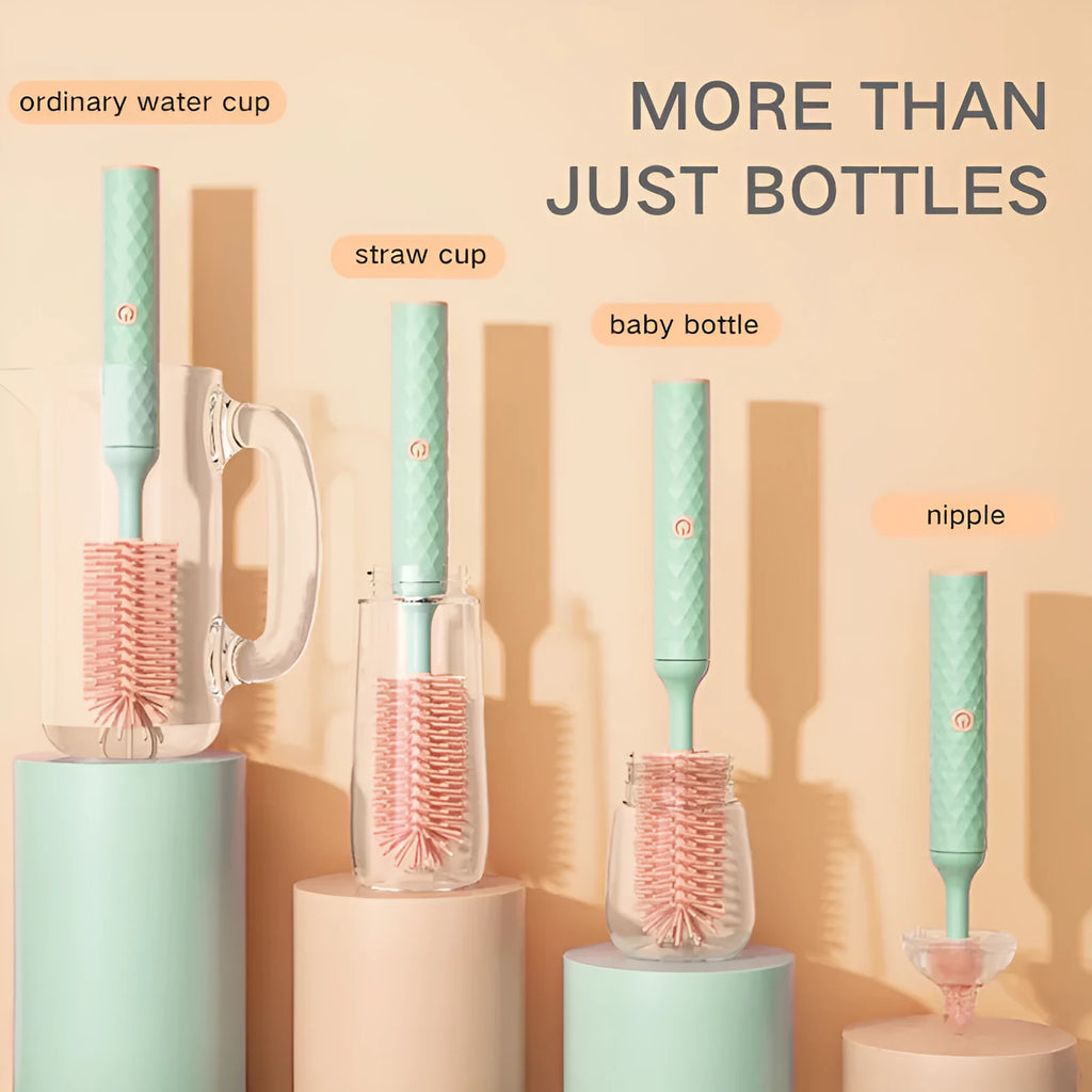 Pink and green electric rotating bottle cleaning brush with silicone bristles on a white background.