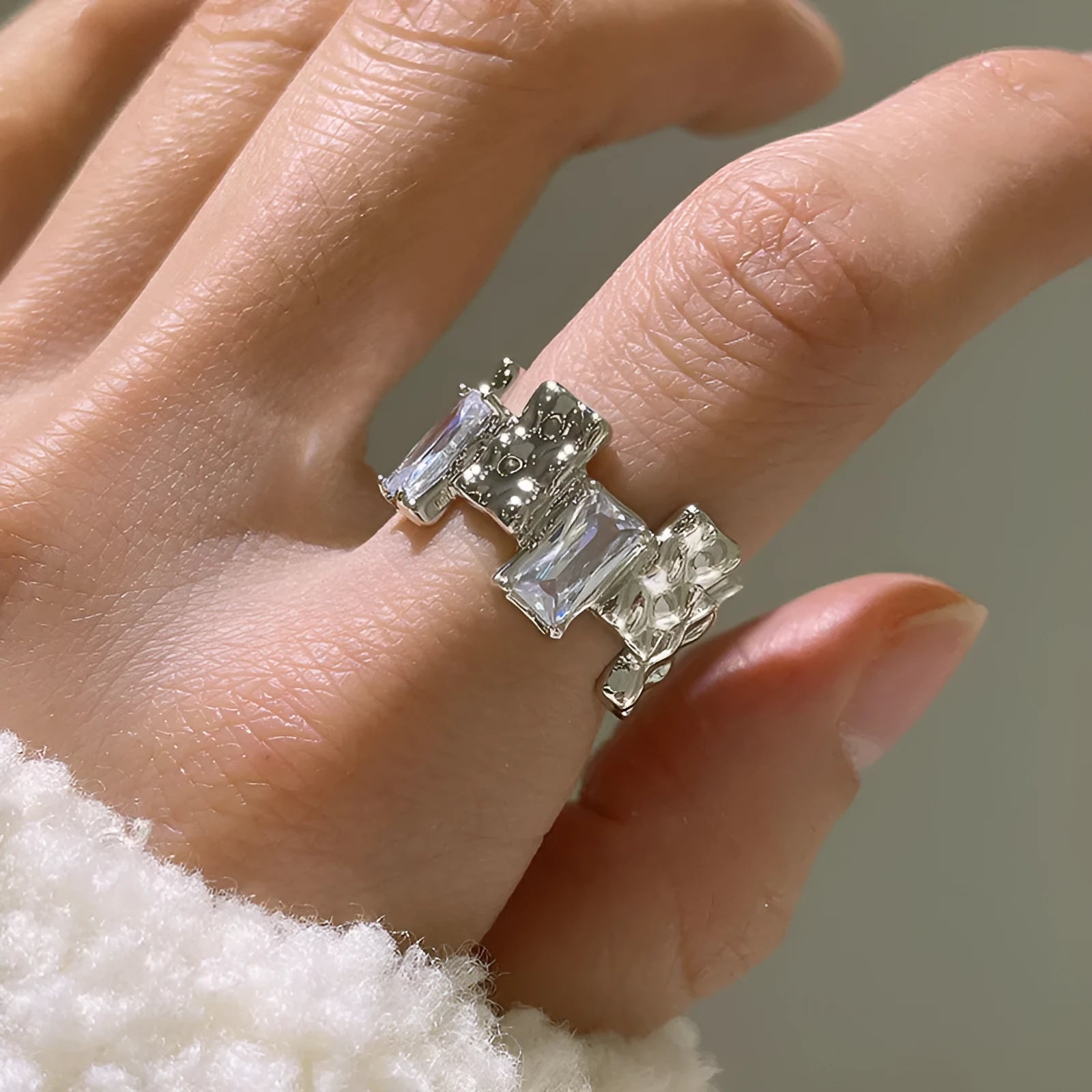 Silver cross ring with geometric design and open gemstone setting