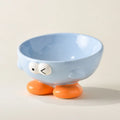 Blue ceramic pet bowl with tall, angled sides and a cute face design for cat or small dog feeding.