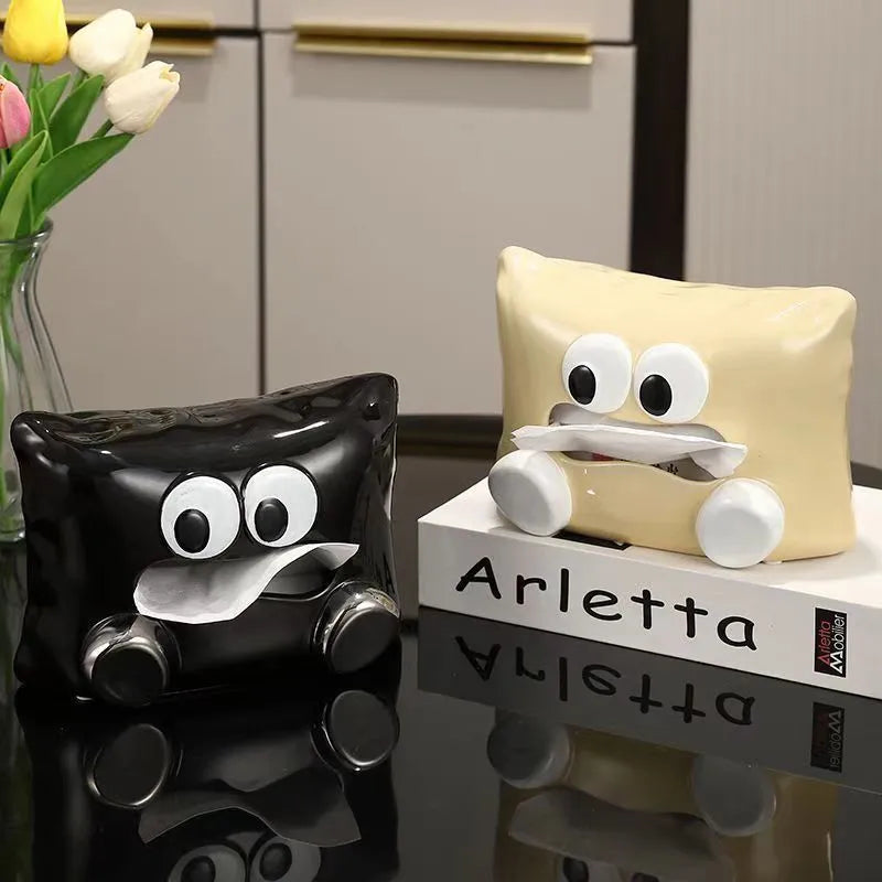 White ceramic tissue box with a smooth, glazed finish on a wooden coffee table.