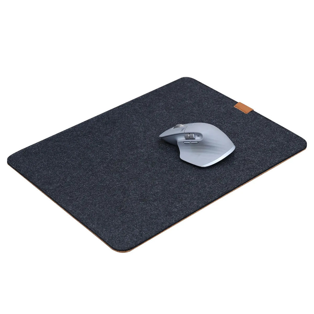 Oversized grey felt and cork office mouse mat on a wooden desk