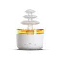 White cloud-shaped USB humidifier and essential oil diffuser with LED lights on a table