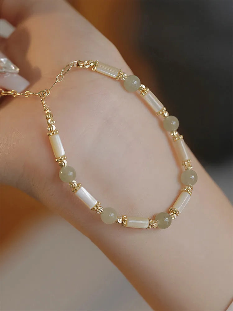 Women's bamboo joint bracelet with polished 6mm Hetian jade or South red agate beads.