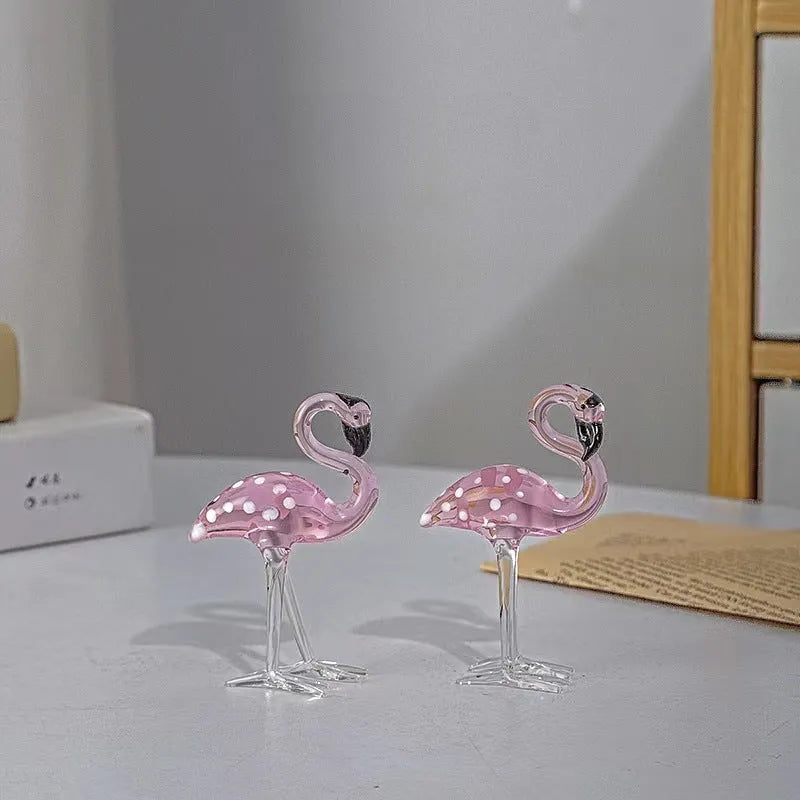 Pink flamingo decorative ornament made of white crystal on a table.